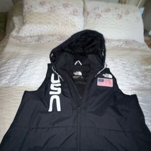 The North Face Black Hooded Vest with USA Logo.